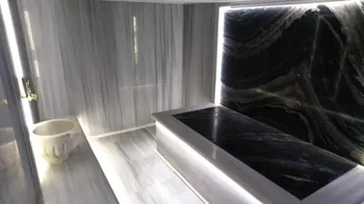 a black tub in a bathroom with a toilet at Atacity Hotel in Istanbul