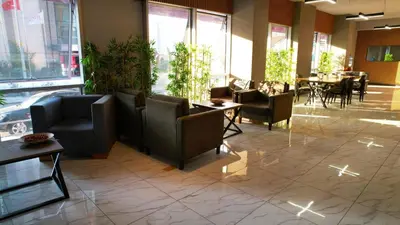 a lobby with chairs and tables in a restaurant at Atacity Hotel in Istanbul