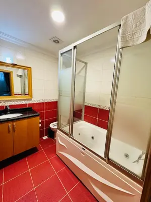 a bathroom with a shower and a toilet and a sink at Grand Papirus Hotel in Istanbul