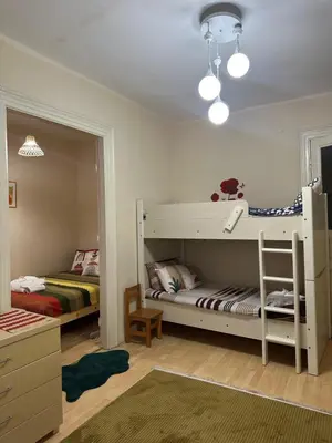 a room with two beds and a bunk bed at Nelly Guesthouse in Istanbul