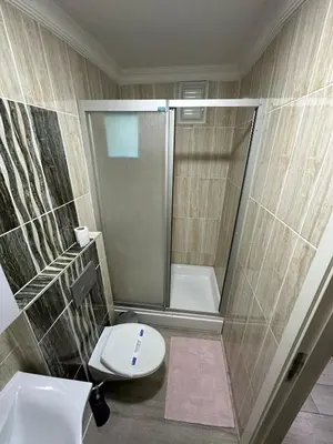 a bathroom with a shower and a toilet and a sink at Nelly Guesthouse in Istanbul