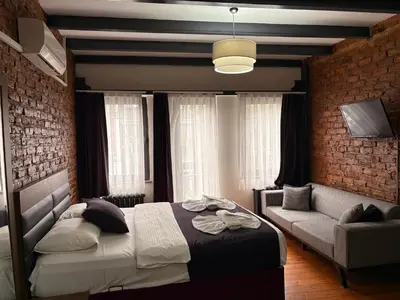 a bedroom with a bed and a couch at Taksim Otto suite in Istanbul
