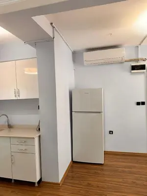 an empty kitchen with a refrigerator in a room at Taksim Otto suite in Istanbul