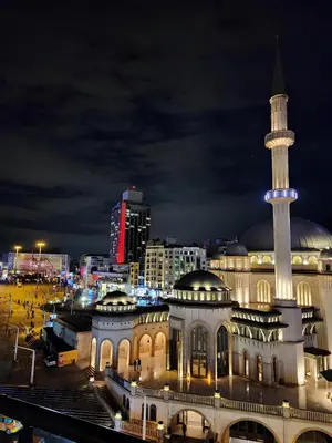 a building with a mosque with a tower at night at Taksim Landhouse Hotel in Istanbul