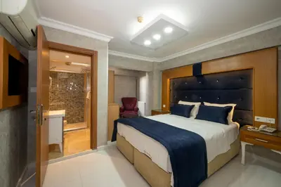 a bedroom with a large bed and a window at Tamara Residence Hotel İstanbul in Istanbul