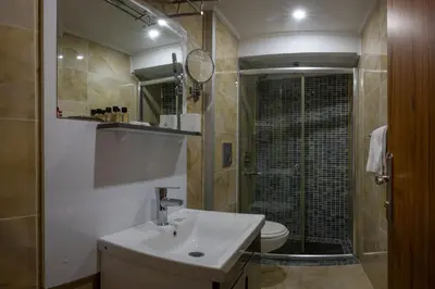 a bathroom with a sink and a shower with a toilet at Tamara Residence Hotel İstanbul in Istanbul