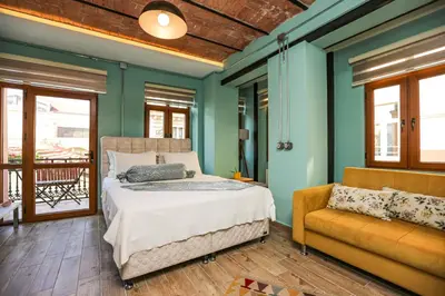 a bedroom with a bed and a couch at No 8 Galata in Istanbul