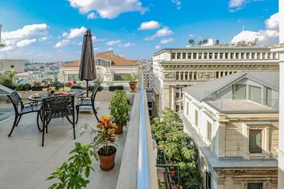 a balcony with an umbrella and a table and chairs at No 8 Galata in Istanbul