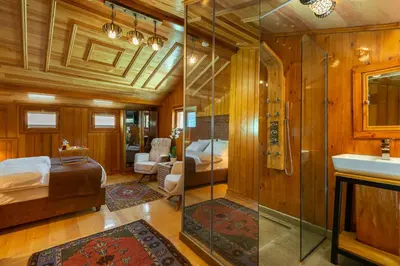 a bathroom with a shower and a bed and a sink at Wonder Wood Hotel in Istanbul