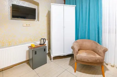 a living room with a chair and a table at Taksim Dora Hotel in Istanbul
