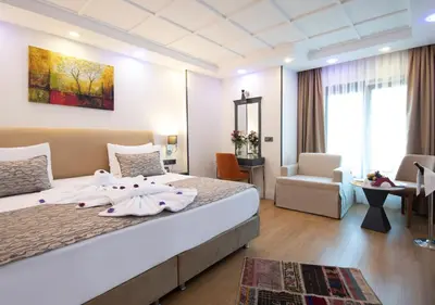 a hotel room with a bed with towels on it at Antusa Design Hotel & Spa in Istanbul