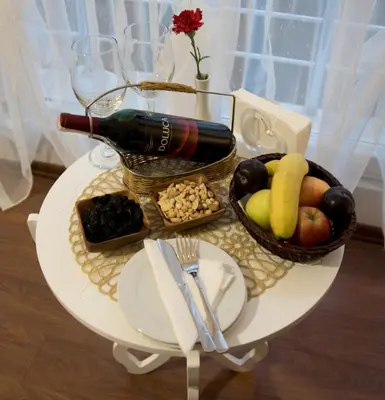 a table with a bottle of wine and a basket of fruit at Genius Hotel Istanbul in Istanbul