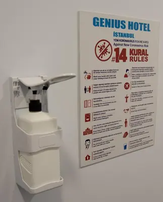 a sign on a wall next to a sewing machine at Genius Hotel Istanbul in Istanbul