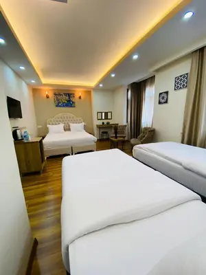 a hotel room with two beds and a desk at PALMERA OLD CITY in Istanbul
