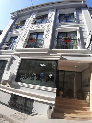 a white building with windows and balconies at OBAHAN HOTEL-Special Class in Istanbul