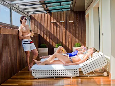 a man and two women laying on beds in a room at Lasagrada Hotel Istanbul in Istanbul