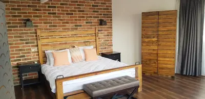 a bedroom with a bed and a brick wall at Fuego Design Suites in Istanbul