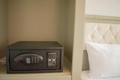 a small microwave sitting on a bed next to a pillow at Mayer Hotel Istanbul in Istanbul