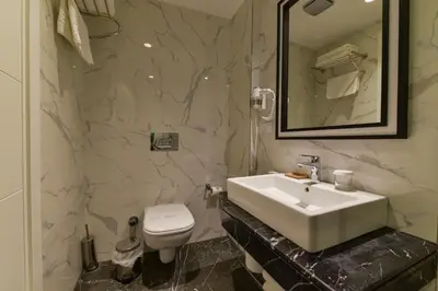 a bathroom with a white sink and a toilet at Kare Hotel Sultanahmet in Istanbul