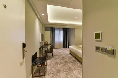 a hotel room with a bed and a desk at Kare Hotel Sultanahmet in Istanbul