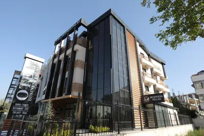 a building with glass windows on a city street at BUSINESSPALAS DELUXE in Izmit