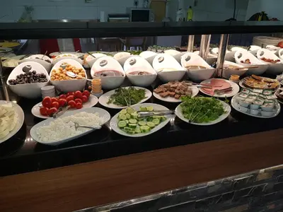 a buffet with many plates of food on a table at BUSINESSPALAS DELUXE in Izmit