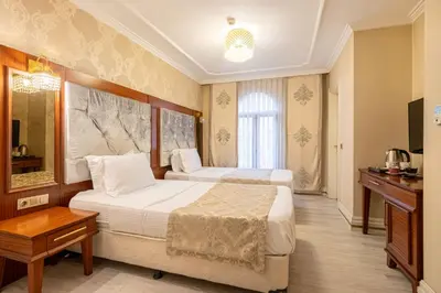 a hotel room with two beds and a table at Myy Boutique Hotel in Istanbul