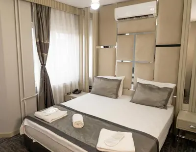 a hotel room with a bed and a window at Grand Heykel Hotel in Bursa