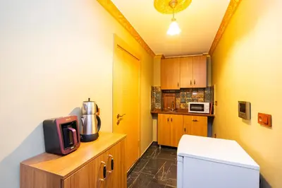 a small kitchen with a tv on top of a counter at The Ottoman Desing Suit in Istanbul
