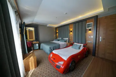 a hotel room with a bed and a car in it at Green Prusa Hotel in Bursa
