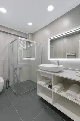 a bathroom with a sink and a shower and a mirror at On4 Rooms & Suites in Istanbul