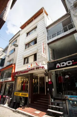 a white building with a hotel on a city street at Grand Bagoz Hotel in Istanbul