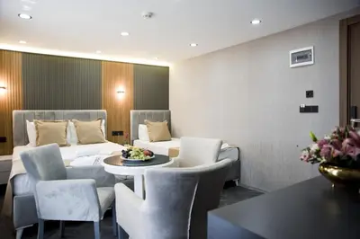 a hotel room with a bed and a table and chairs at Grand Bagoz Hotel in Istanbul