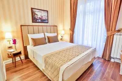 a bedroom with a large bed and a large window at HANENDE HOTEL in Istanbul