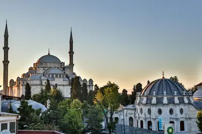 a mosque with two domes and another mosque in a city at HANENDE HOTEL in Istanbul