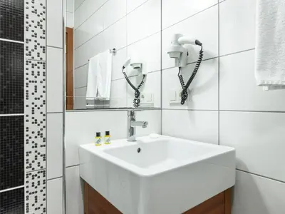 a white bathroom with a sink and a shower at Mint Residence Taksim in Istanbul