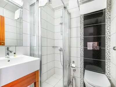 a bathroom with a sink and a shower at Mint Residence Taksim in Istanbul
