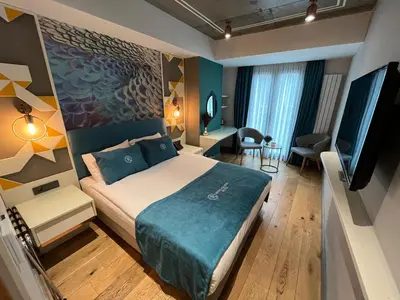 a hotel room with a bed and a flat screen tv at Royal Galata Hotel in Istanbul