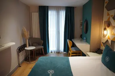 a hotel room with a bed and a desk and chair at Royal Galata Hotel in Istanbul