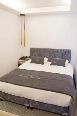 a bedroom with a large bed with a gray headboard at The 22 Hotel in Istanbul