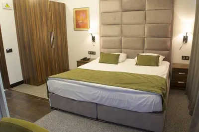 a bedroom with a large bed with a large headboard at The 22 Hotel in Istanbul