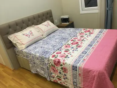 a bed with a quilt and a pillow on it at PASHA APART~BOUTİQUE HOTEL/YALOVA in Yalova