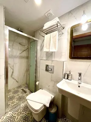 a bathroom with a toilet and a sink at Zem Hotel in Istanbul