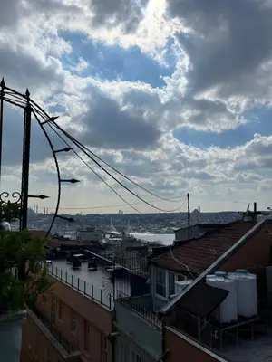 a view of a city under a cloudy sky at Ganbaru Tours - Flats in Galata in Istanbul