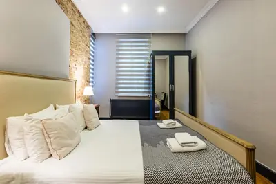 a bedroom with a bed with two towels on it at Ganbaru Tours - Flats in Galata in Istanbul