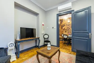 a living room with a couch and a tv and a table at Ganbaru Tours - Flats in Galata in Istanbul