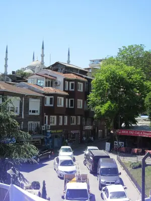 a parking lot with cars parked in front of a building at Sultan Apartments in Istanbul