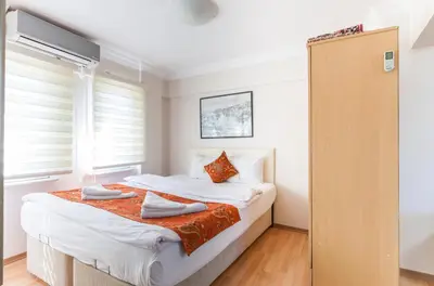 a bedroom with a bed with white sheets and pillows at Sultan Apartments in Istanbul
