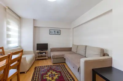 a living room with a couch and a tv at Sultan Apartments in Istanbul