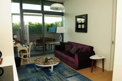 a living room with a purple couch and a table at Ataköy Marina Park Hotel Residence in Istanbul